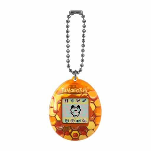 Tamagotchi-virtuaalilemmikkilelu, joka on koristeltu hunajakennokuviolla